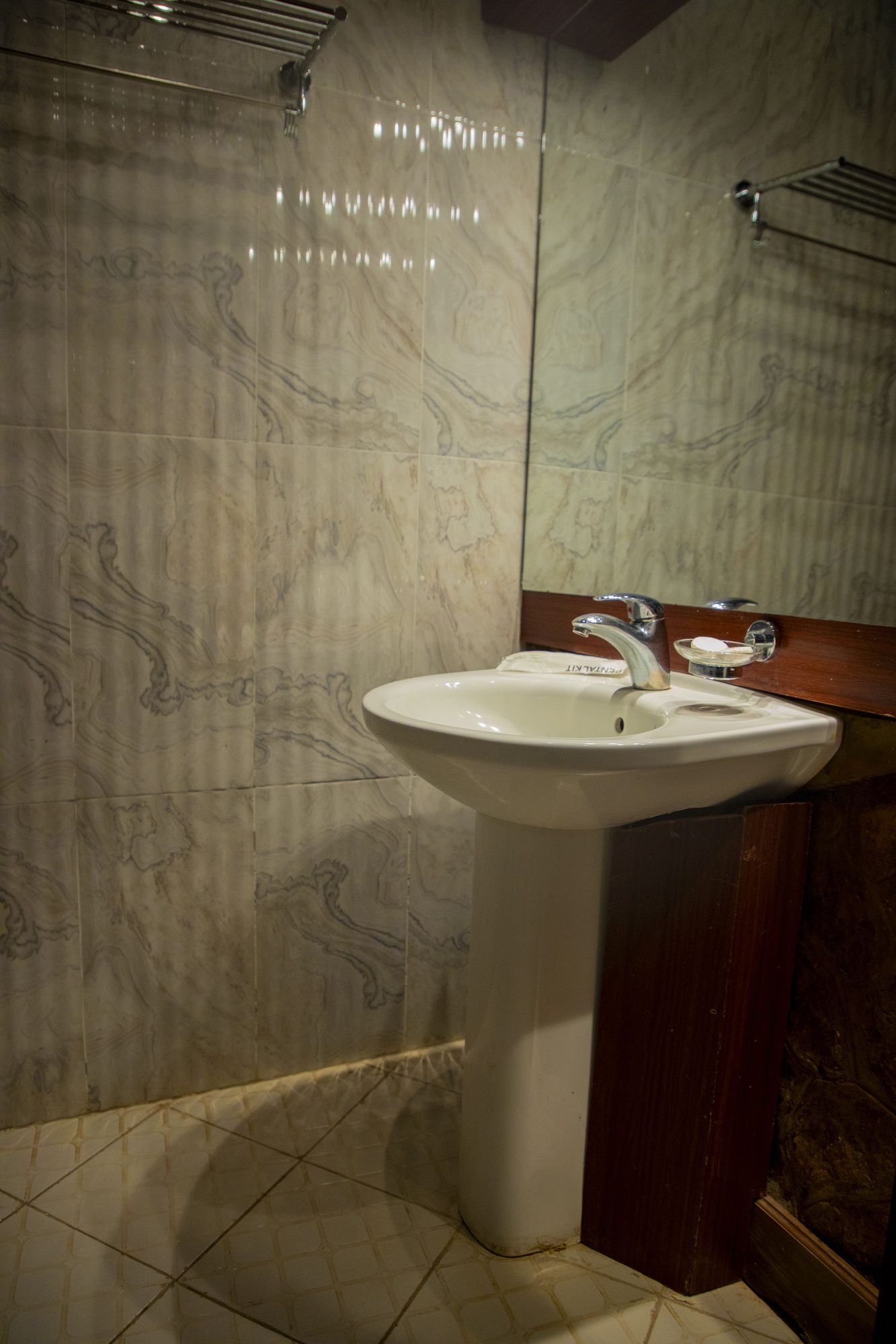 Marble bathroom with pedestal sink at Saivilla Hotel